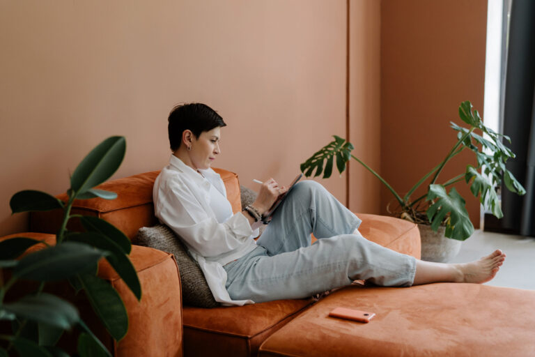 Woman journaling in soft natural light while finding freedom after divorce and healing from bitterness after divorce.